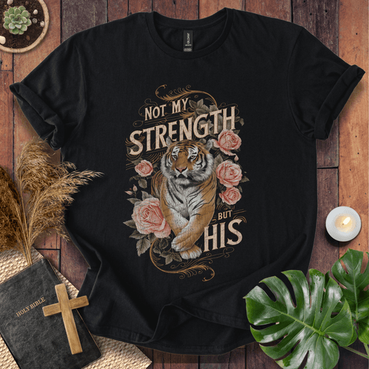Not My Strength But His Christian t-shirt in black—tiger with roses and vintage script faith design.