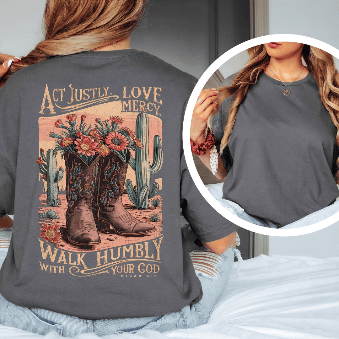 Rear view of a woman wearing Micah 6:8 t-shirt from Black.jpg, featuring western cowboy boots, cacti, and desert wildflowers.