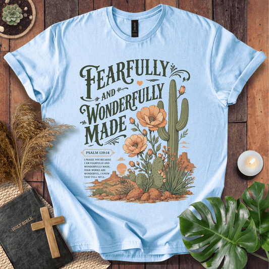 t-shirt featuring a saguaro cactus, desert flowers, and the text Fearfully and Wonderfully Made Psalm 139:14.