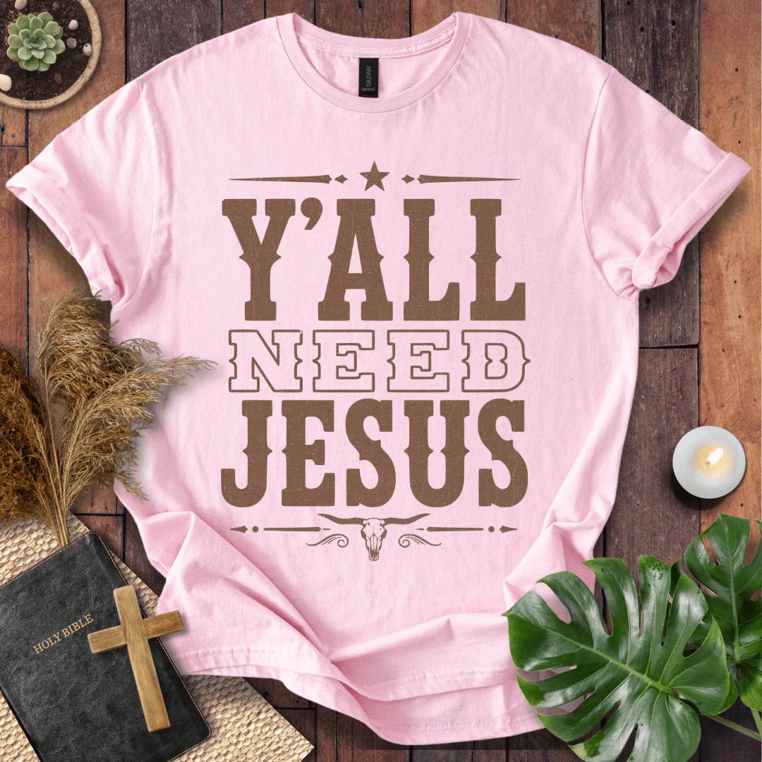 Y'all Need Jesus country western graphic tee with a longhorn skull design next to a Bible and cross.