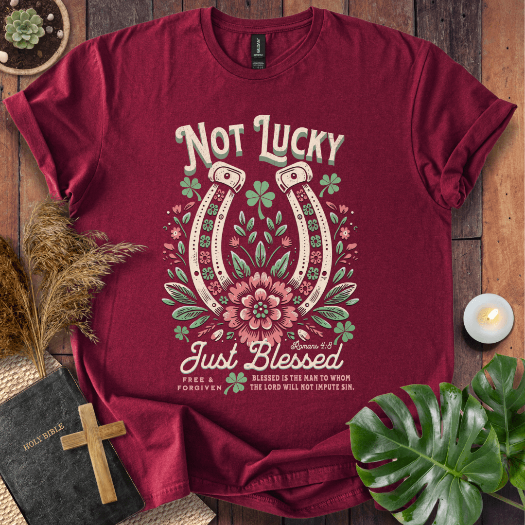 “Not Lucky, Just Blessed” Romans 4:8 Christian t-shirt with twin horseshoes, clovers, and florals; western faith tee.