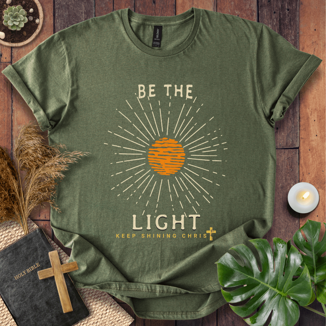 Be the Light Christian t-shirt—radiant sunburst with “Keep Shining Christ,” inspired by Matthew 5:14–16.