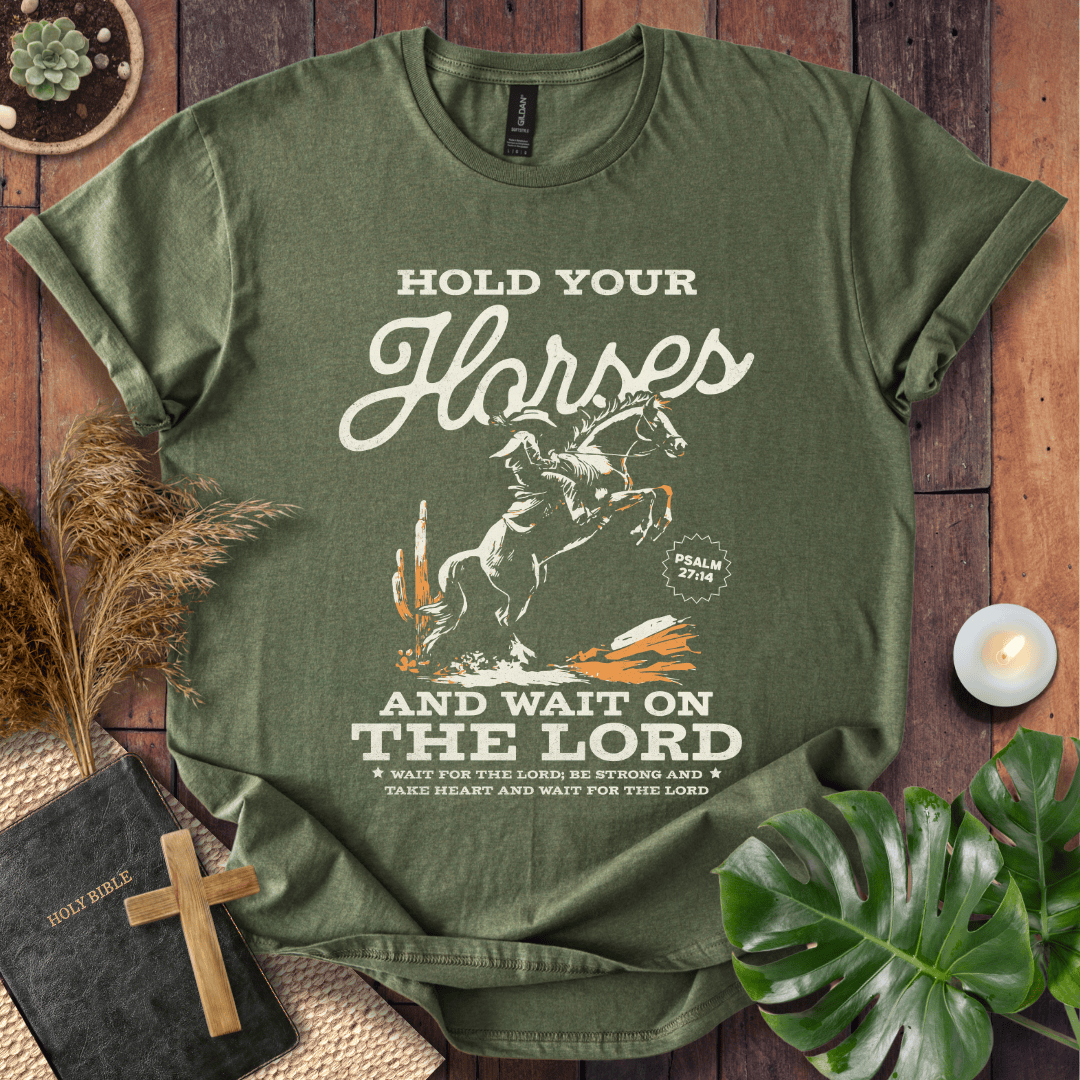 Black western t-shirt featuring a cowboy on a rearing horse with the text Hold Your Horses and Psalm 27:14 bible verse.