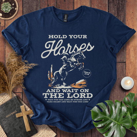 Black western t-shirt featuring a cowboy on a rearing horse with the text Hold Your Horses and Psalm 27:14 bible verse.