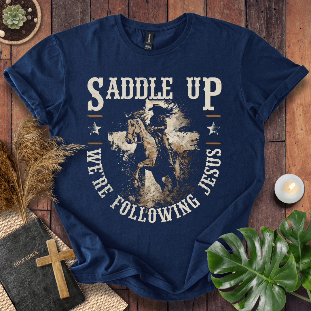 t-shirt featuring a horse and rider silhouette on a cross with text Saddle Up We're Following Jesus in a vintage style.