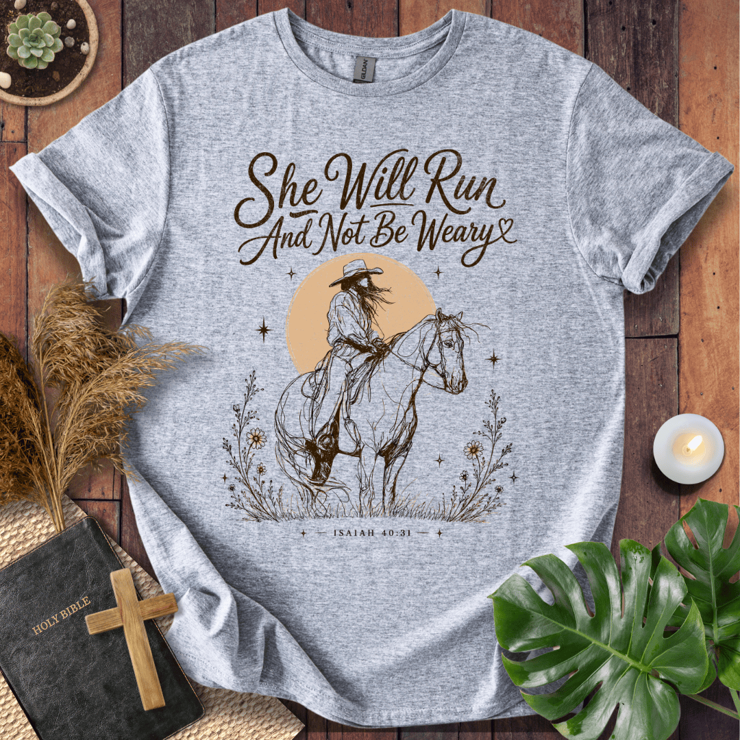 A vintage cream t-shirt featuring a sketched cowgirl on a horse under a desert sun with Isaiah 40:31.