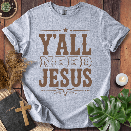Y'all Need Jesus country western graphic tee with a longhorn skull design next to a Bible and cross.