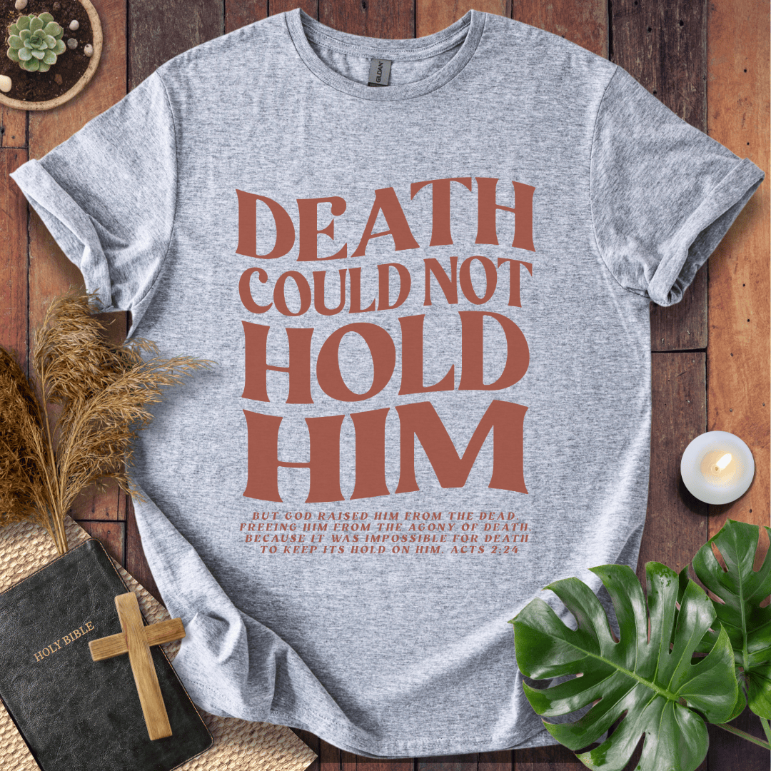 Christian Easter t-shirt with "Death Could Not Hold Him" Acts 2:24 text, styled with a Bible and wooden cross