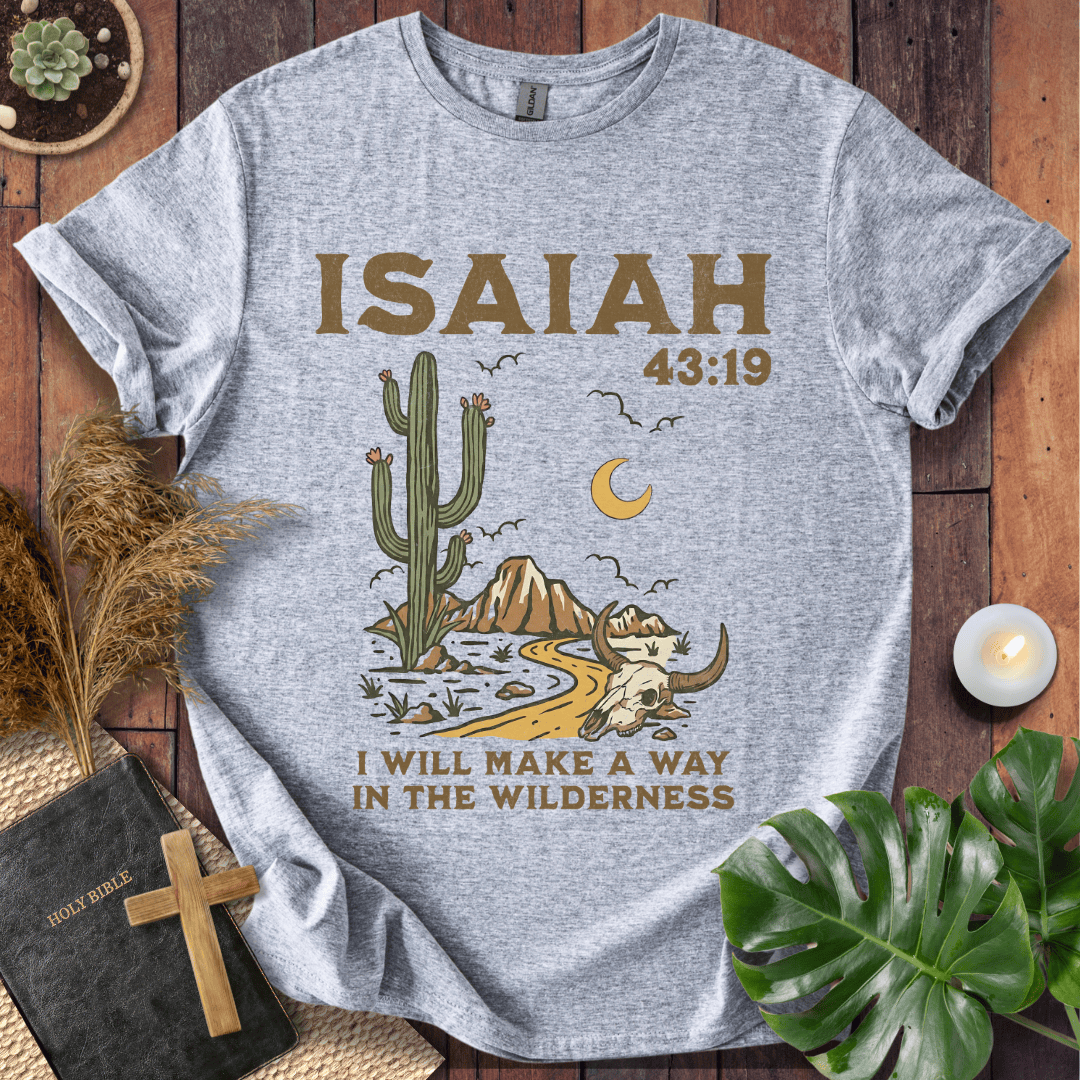 Gray t-shirt with cactus graphic and 'ISAIAH 43:19' text on a wooden surface.