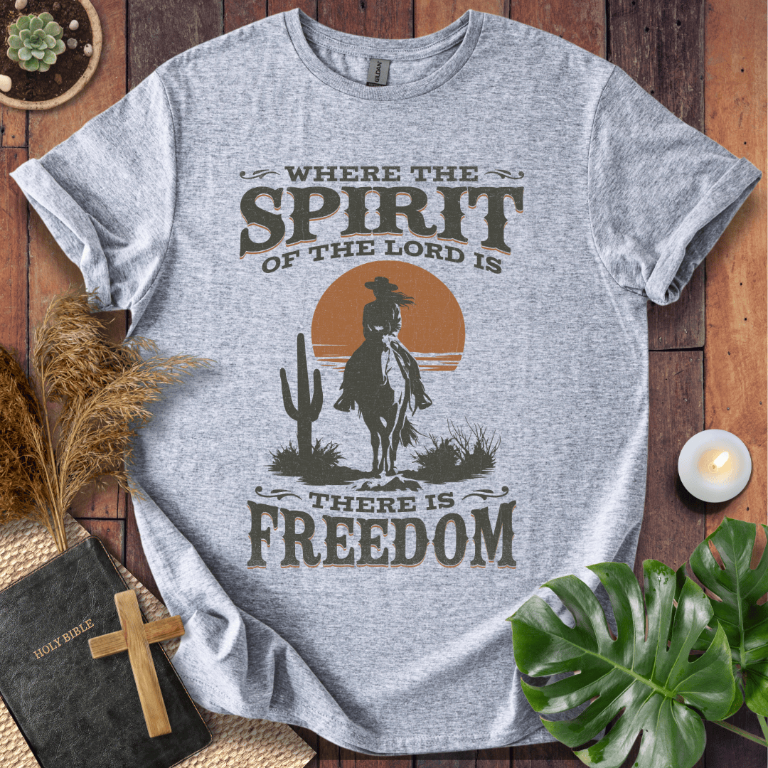 A Western tee featuring a horse rider, cactus, and sunset with the bible verse 2 Corinthians 3:17.