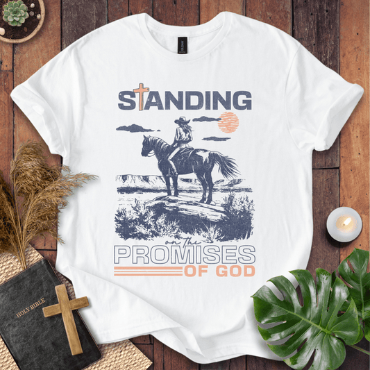 Standing on the Promises of God Christian t-shirt—cowgirl on horseback in western landscape with bold typographic message.