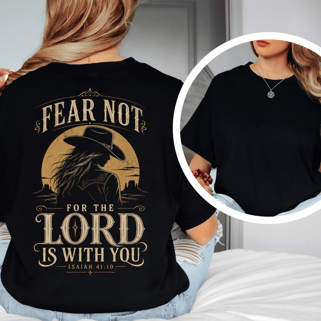 t-shirt showing a cowgirl silhouette in front of a desert sun with the words Fear Not Isaiah 41:10.