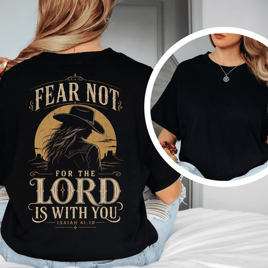t-shirt showing a cowgirl silhouette in front of a desert sun with the words Fear Not Isaiah 41:10.