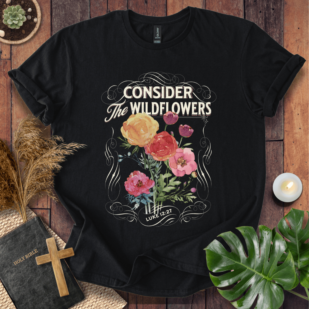 Christian t-shirt with watercolor wildflowers and Luke 12:27 scripture "Consider the Wildflowers" in a vintage scroll frame.