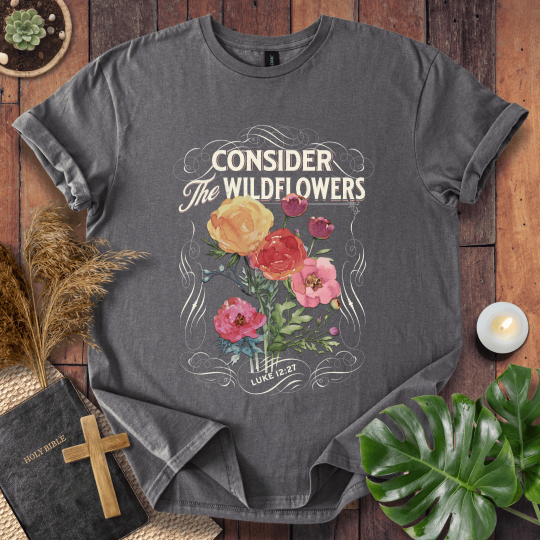 Christian t-shirt with watercolor wildflowers and Luke 12:27 scripture "Consider the Wildflowers" in a vintage scroll frame.