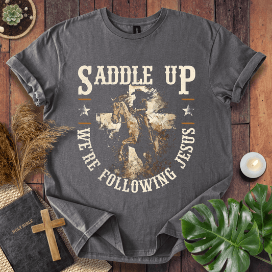 t-shirt featuring a horse and rider silhouette on a cross with text Saddle Up We're Following Jesus in a vintage style.