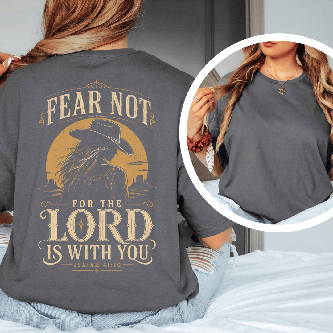 t-shirt showing a cowgirl silhouette in front of a desert sun with the words Fear Not Isaiah 41:10.