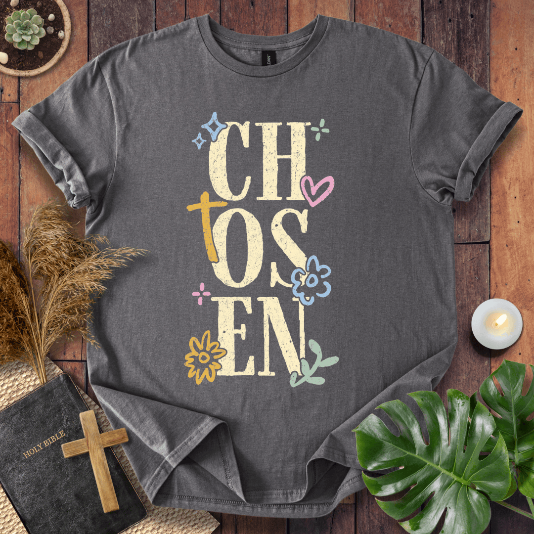 Distressed "CHOSEN" graphic on a t-shirt with a rustic gold cross and colorful boho wildflowers.