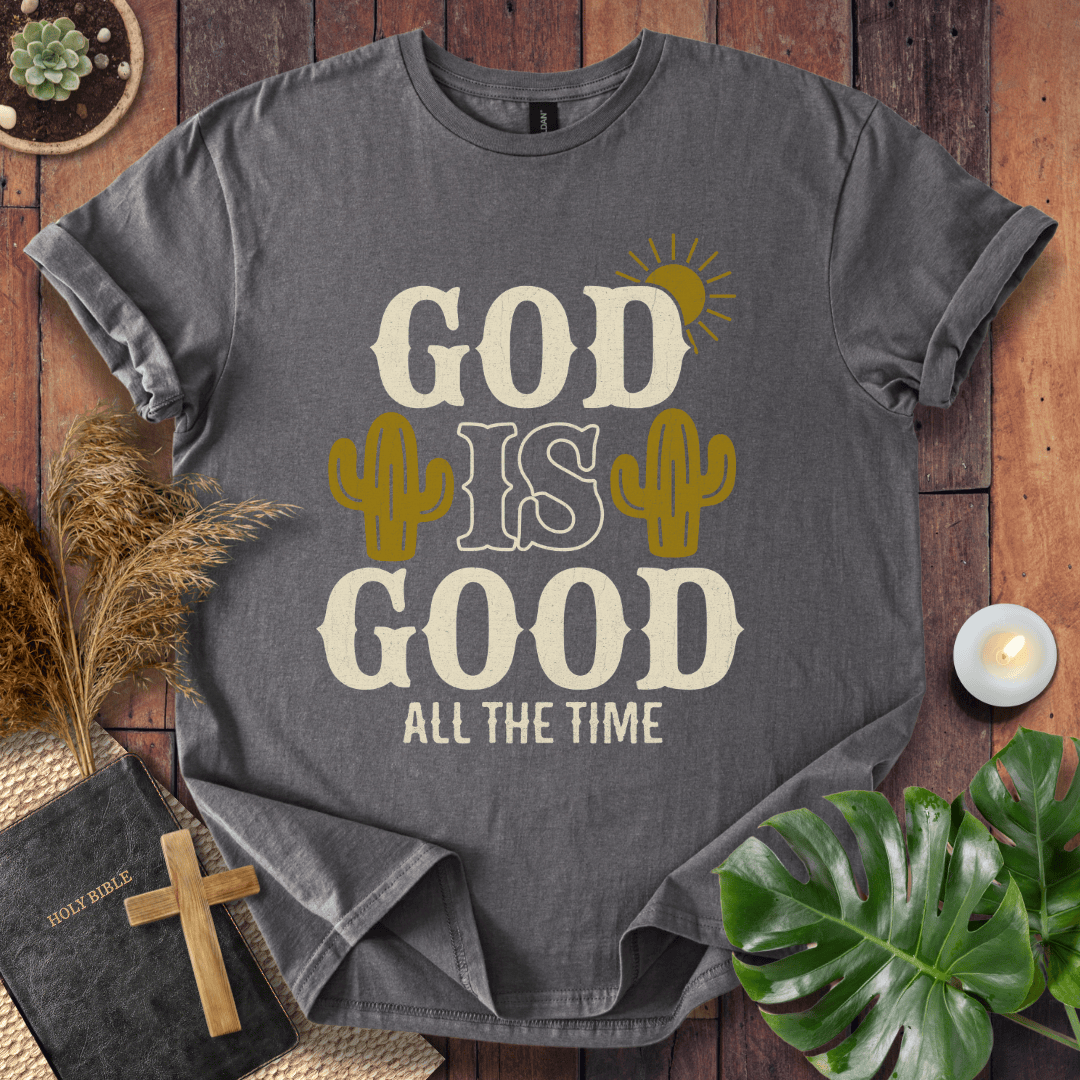 God Is Good All The Time t-shirt with cacti and sun graphics, styled with a Bible and wooden cross.