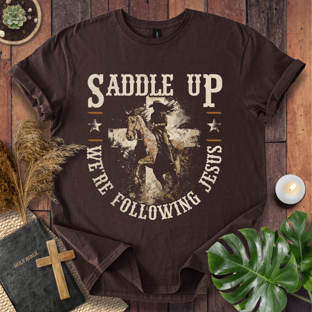 t-shirt featuring a horse and rider silhouette on a cross with text Saddle Up We're Following Jesus in a vintage style.