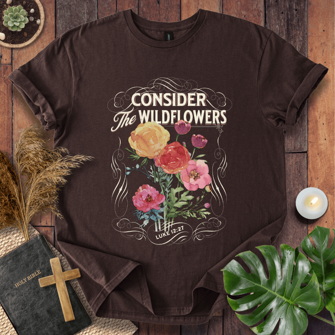 Christian t-shirt with watercolor wildflowers and Luke 12:27 scripture "Consider the Wildflowers" in a vintage scroll frame.