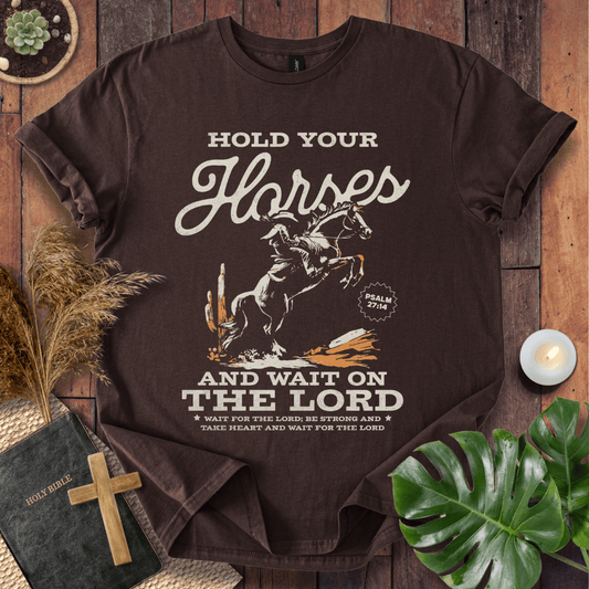 Black western t-shirt featuring a cowboy on a rearing horse with the text Hold Your Horses and Psalm 27:14 bible verse.