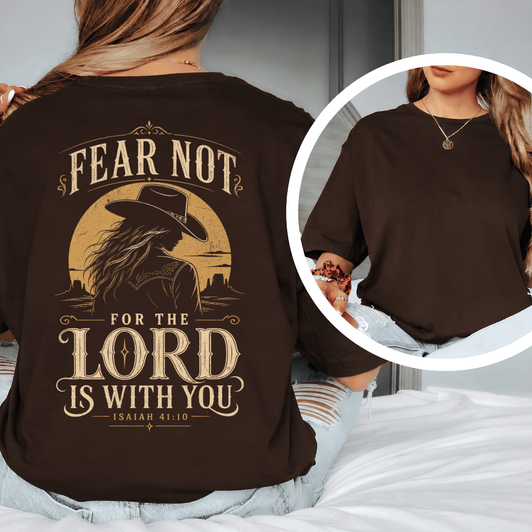 t-shirt showing a cowgirl silhouette in front of a desert sun with the words Fear Not Isaiah 41:10.
