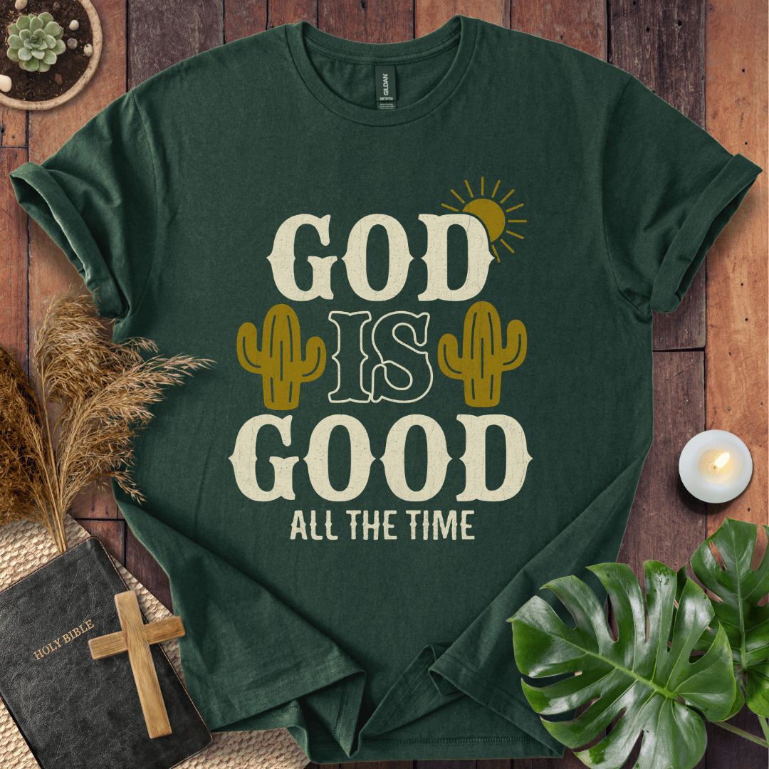 God Is Good All The Time t-shirt with cacti and sun graphics, styled with a Bible and wooden cross.