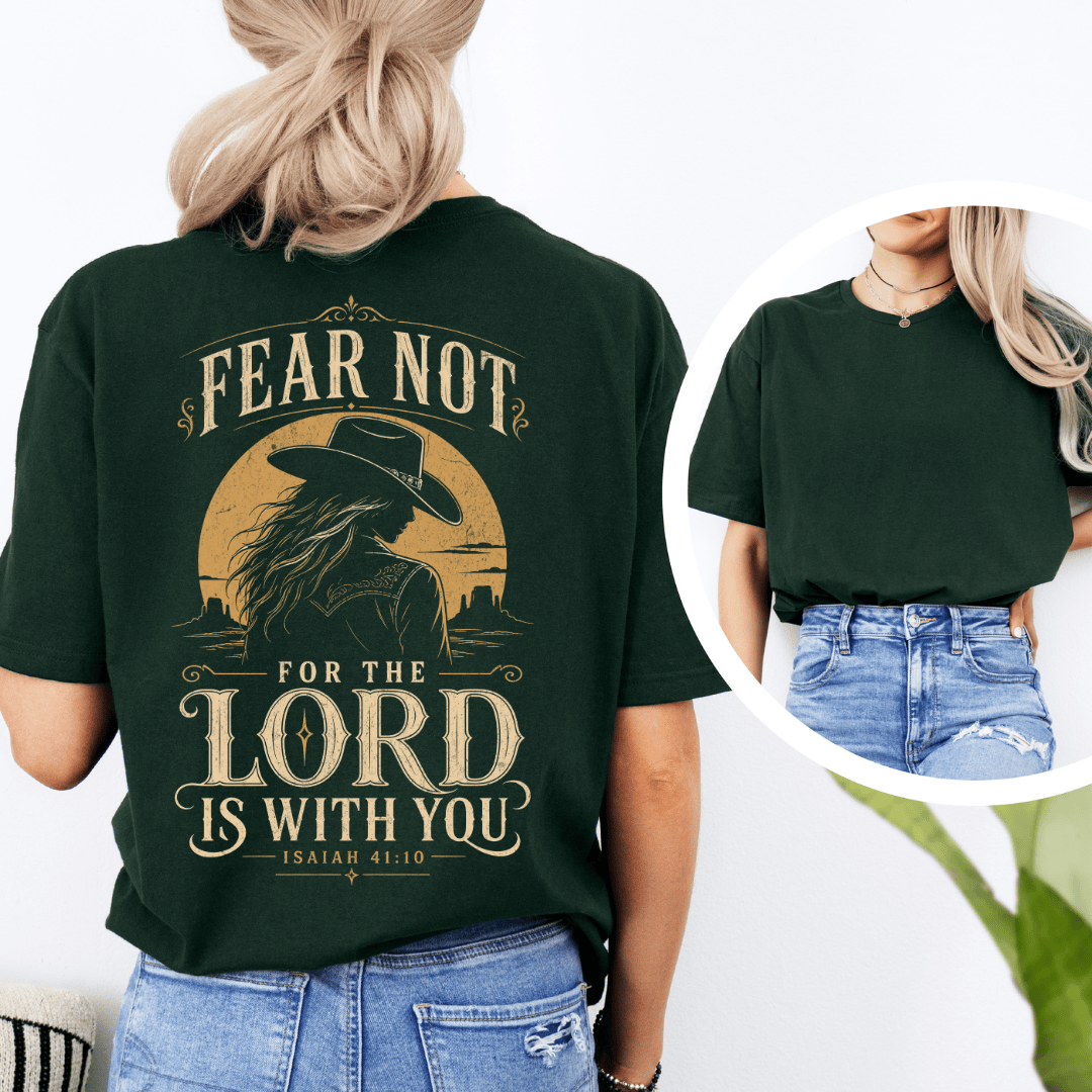 t-shirt showing a cowgirl silhouette in front of a desert sun with the words Fear Not Isaiah 41:10.