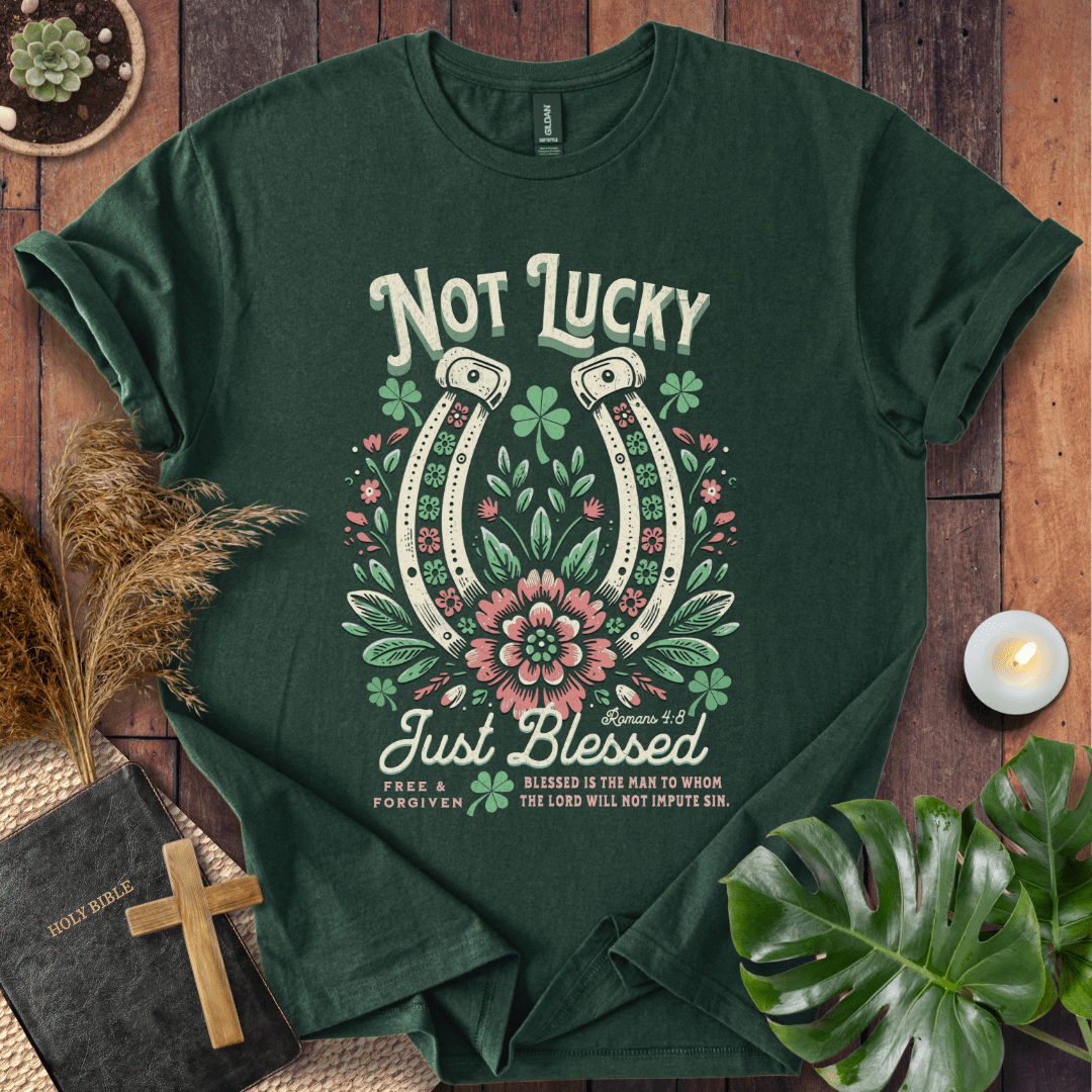 “Not Lucky, Just Blessed” Romans 4:8 Christian t-shirt with twin horseshoes, clovers, and florals; western faith tee.