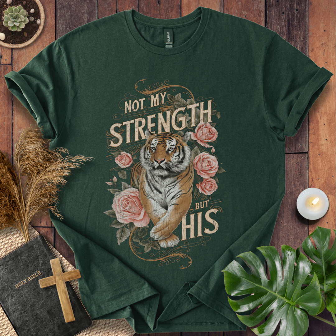 Not My Strength But His Christian t-shirt in black—tiger with roses and vintage script faith design.