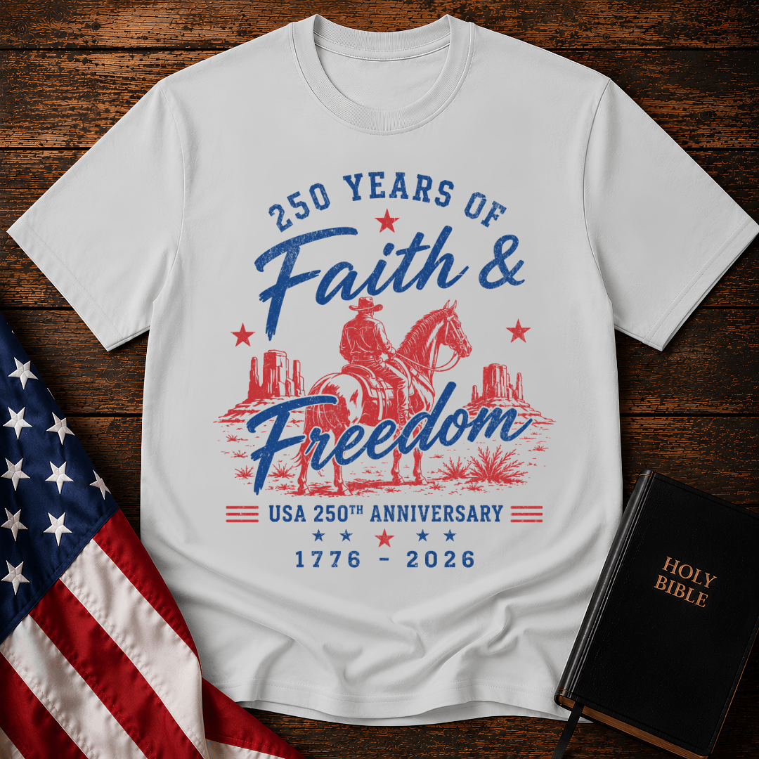 Christian t shirt for women featuring a cowboy on a horse looking at canyon mesas with Faith & Freedom text.