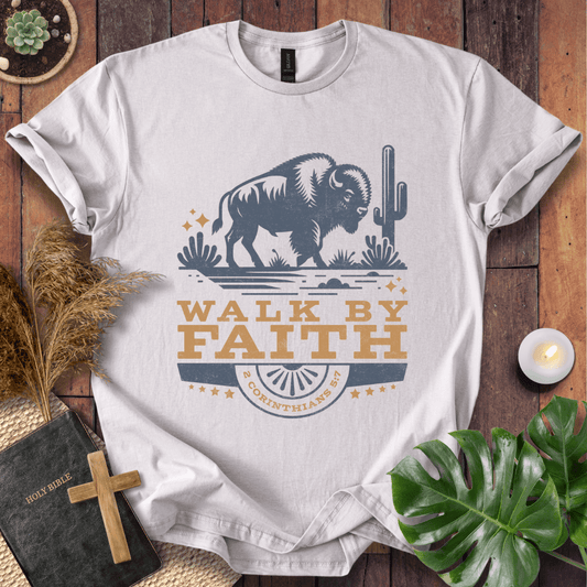 Vintage bison graphic on a shirt with Walk By Faith 2 Corinthians 5:7 text and desert cacti imagery.