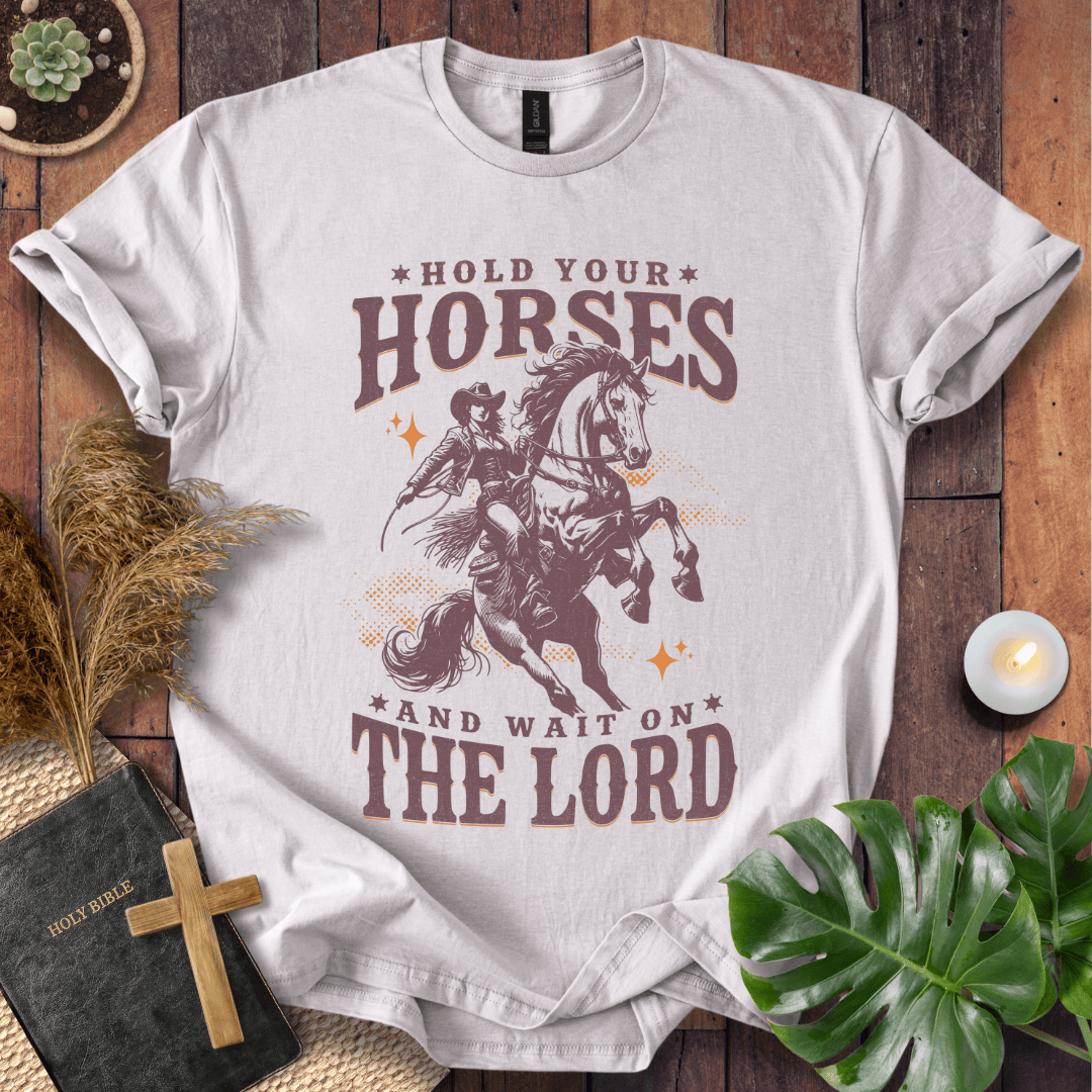 Cowgirl riding a rearing horse on a t-shirt with text saying Hold Your Horses and Wait on the Lord.