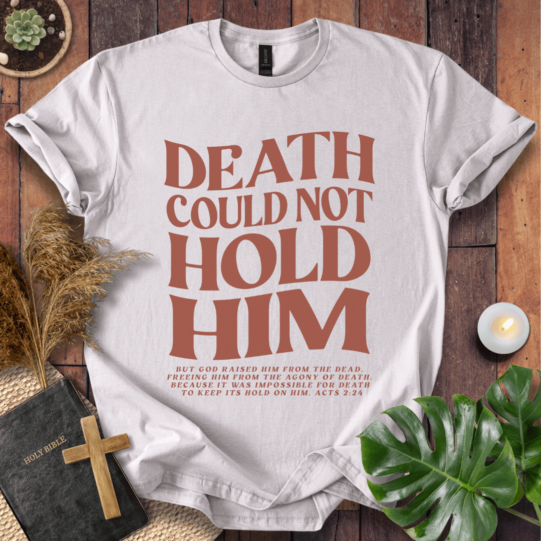 Christian Easter t-shirt with "Death Could Not Hold Him" Acts 2:24 text, styled with a Bible and wooden cross.