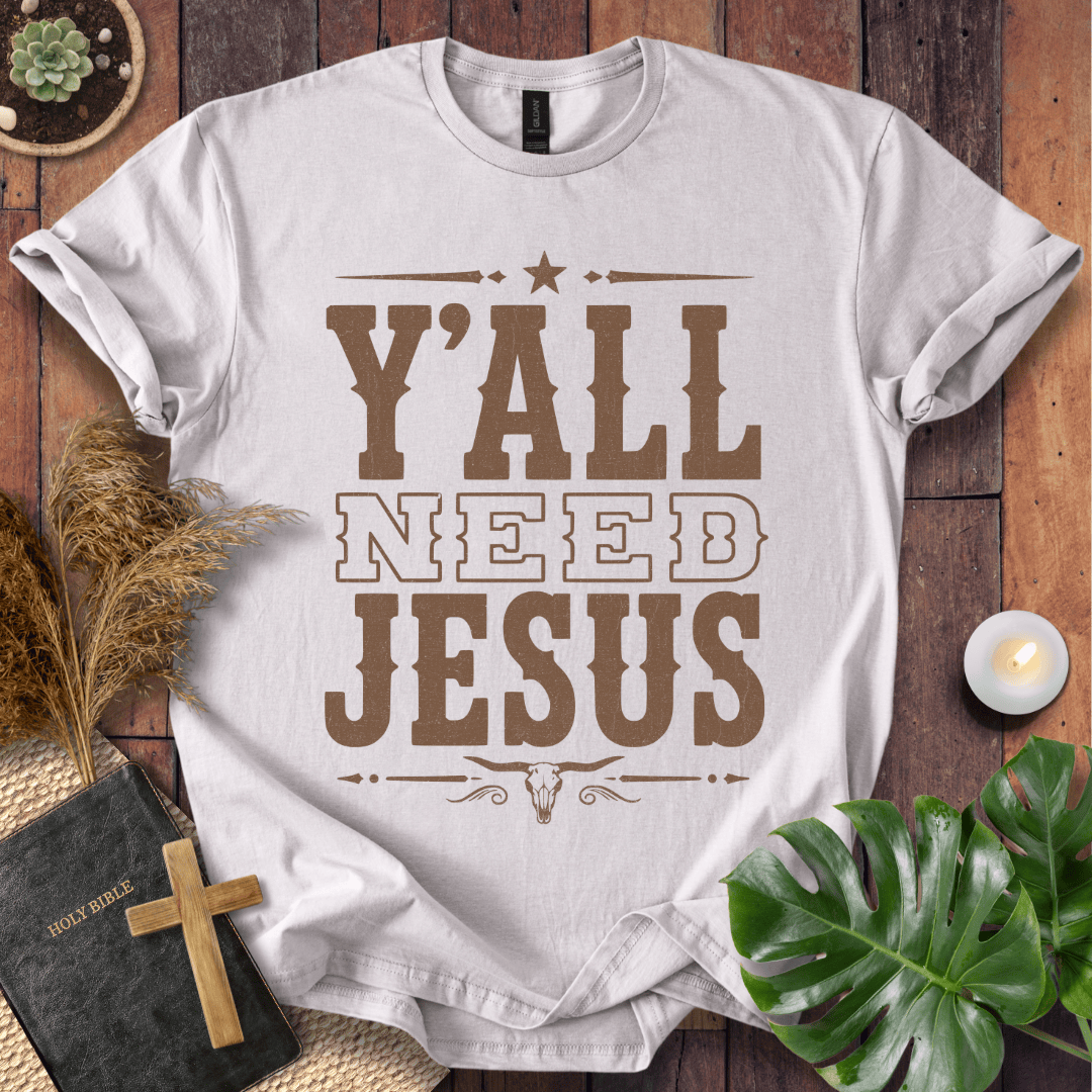Y'all Need Jesus country western graphic tee with a longhorn skull design next to a Bible and cross.