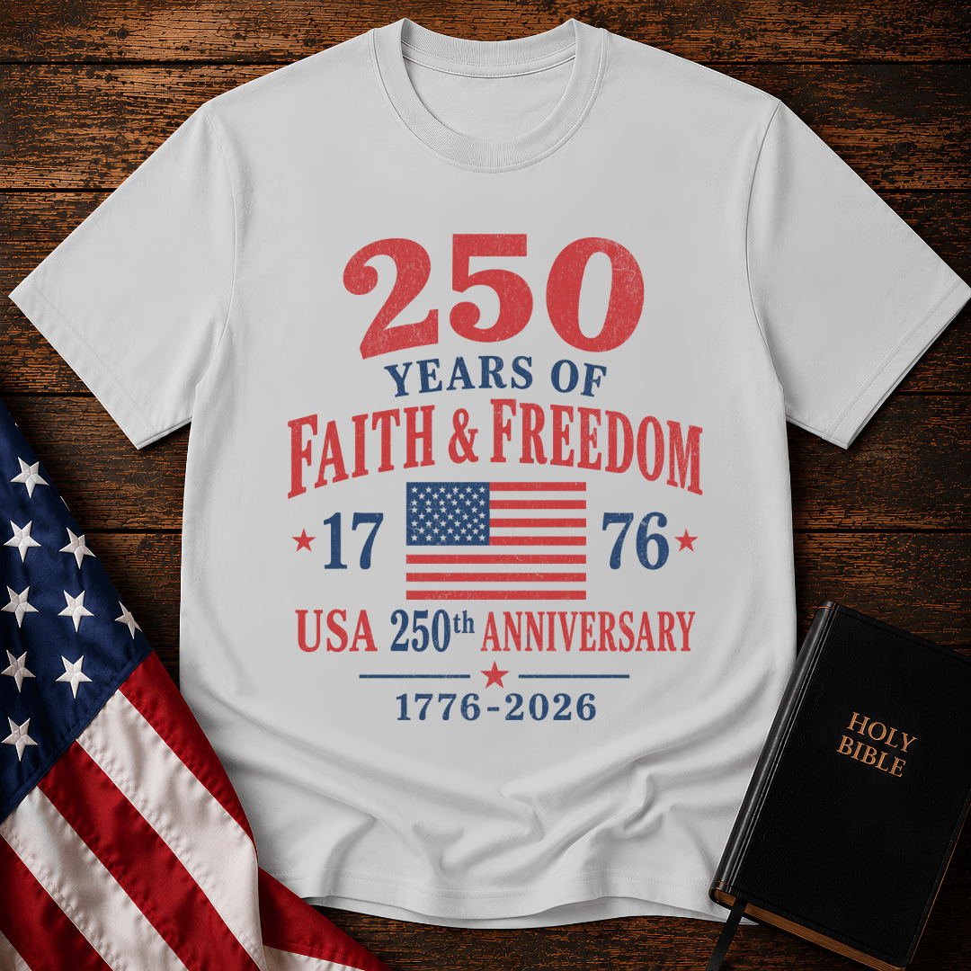 Patriotic t-shirt reading 250 Years of Faith and Freedom 1776 to 2026 with an American flag on a wood background.