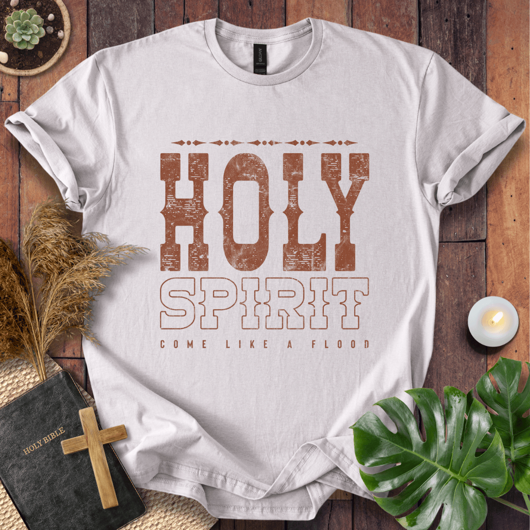 Christian t-shirt with "Holy Spirit Come Like A Flood" in distressed brown western font on a rustic wood background.