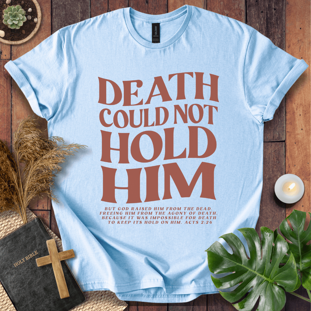 Christian Easter t-shirt with "Death Could Not Hold Him" Acts 2:24 text, styled with a Bible and wooden cross
