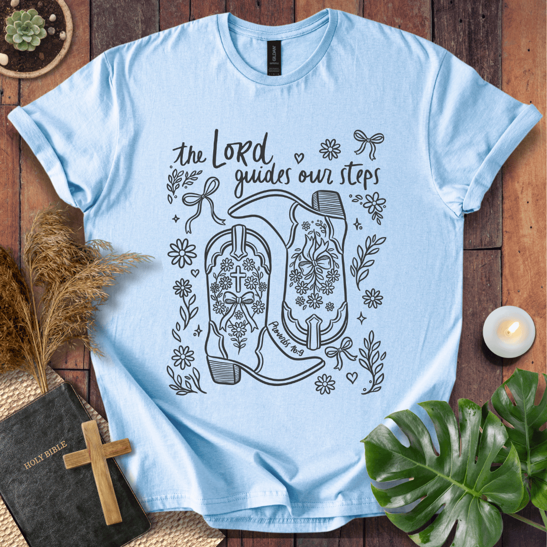 Line art cowboy boots with flowers and bows on a t shirt featuring Proverbs 16:9 "The Lord guides our steps."