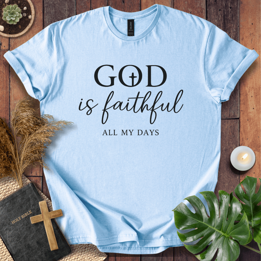 Christian t-shirt reading "God is Faithful All My Days" on a rustic wood background with a Bible and cross.