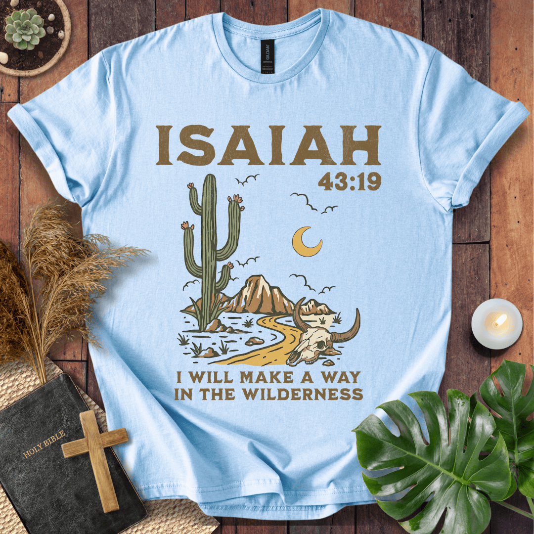 Light blue t-shirt with cactus and mountain design, featuring 'Isaiah 43:19' text on a wooden surface.