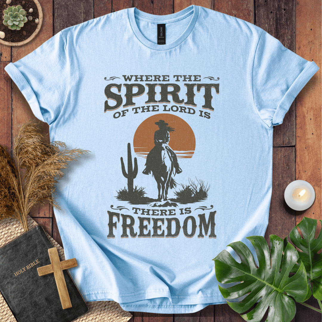 A Western tee featuring a horse rider, cactus, and sunset with the bible verse 2 Corinthians 3:17.
