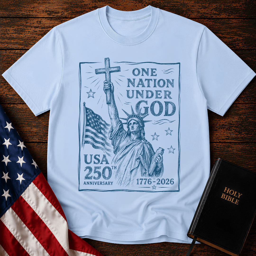 Statue of Liberty holding a cross on a patriotic Christian t shirt next to an American flag and Holy Bible.