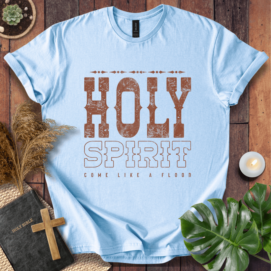 Christian t-shirt with "Holy Spirit Come Like A Flood" in distressed brown western font on a rustic wood background.