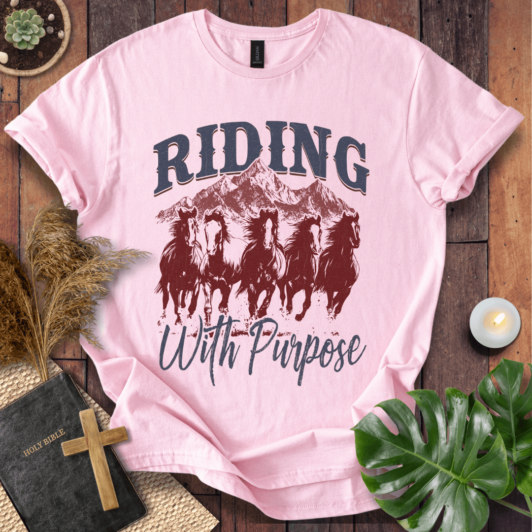t-shirt with navy and rust graphic of five running horses, mountains, and "Riding With Purpose" vintage text.
