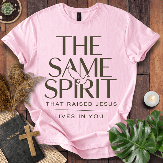 Easter Christian t-shirt with "The Same Spirit That Raised Jesus Lives In You" text and dove icon on wooden background.