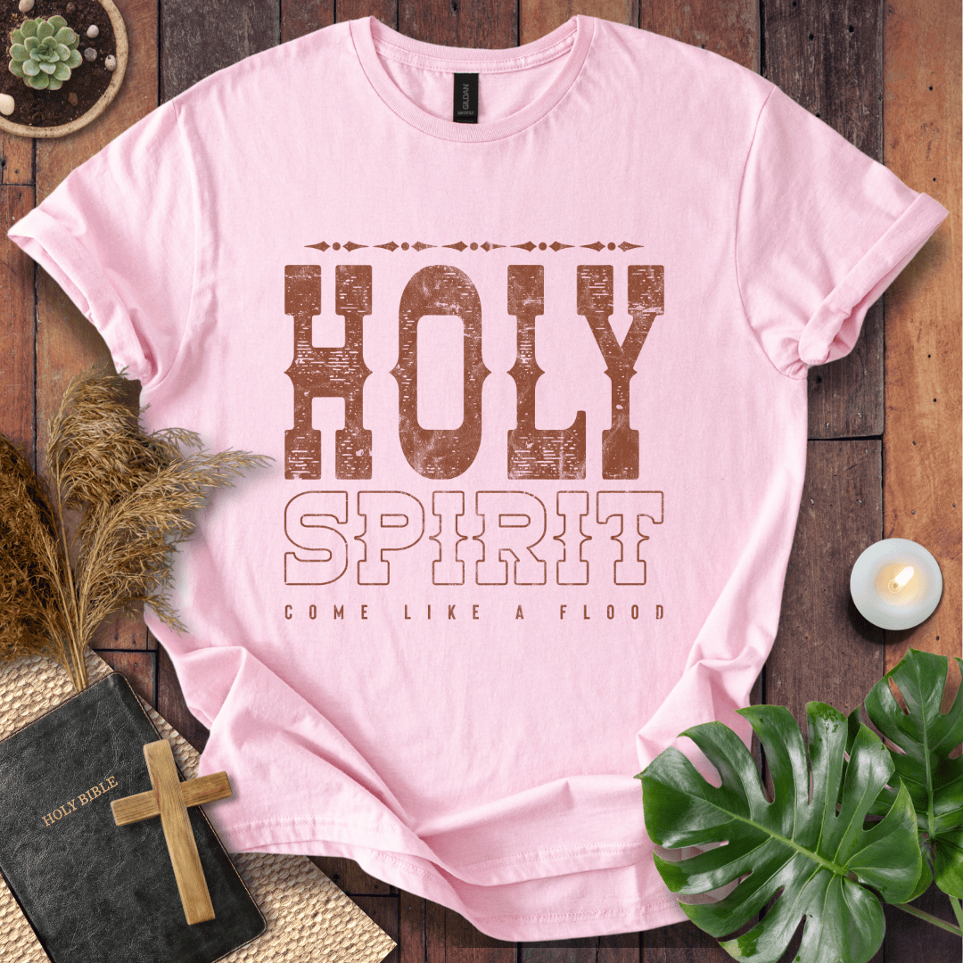 Christian t-shirt with "Holy Spirit Come Like A Flood" in distressed brown western font on a rustic wood background.