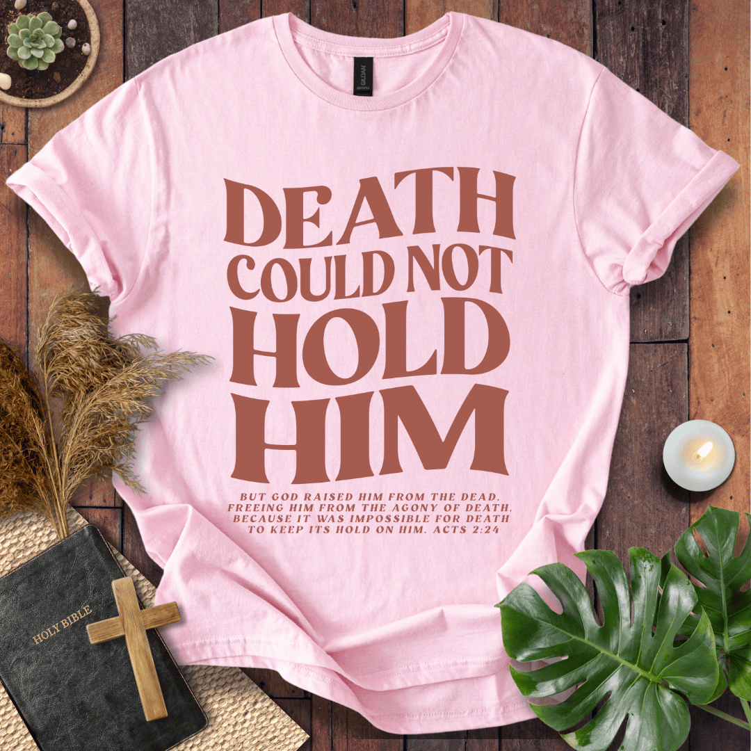 Christian Easter t-shirt with "Death Could Not Hold Him" Acts 2:24 text, styled with a Bible and wooden cross
