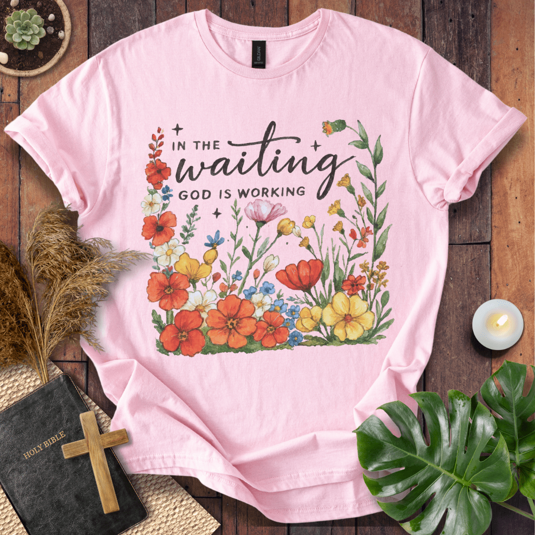 “In the Waiting God Is Working” Christian t-shirt with hand-lettered script and floral frame; encouragement faith tee.
